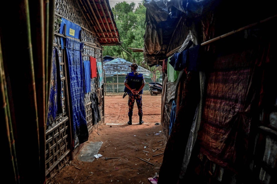 A member of the Armed Police Battalion stands guard at the Kutupalong refugee camp in Ukhia, Bangladesh, October 5, 2021. 