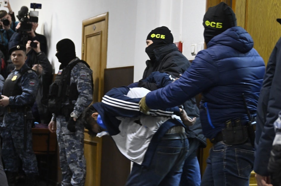 Federal Security Service officials bring Dalderjon Mirzoev, a suspect in the Crocus City Hall's massacre, to the Basmanny District Court in Moscow on March 24, 2024. 