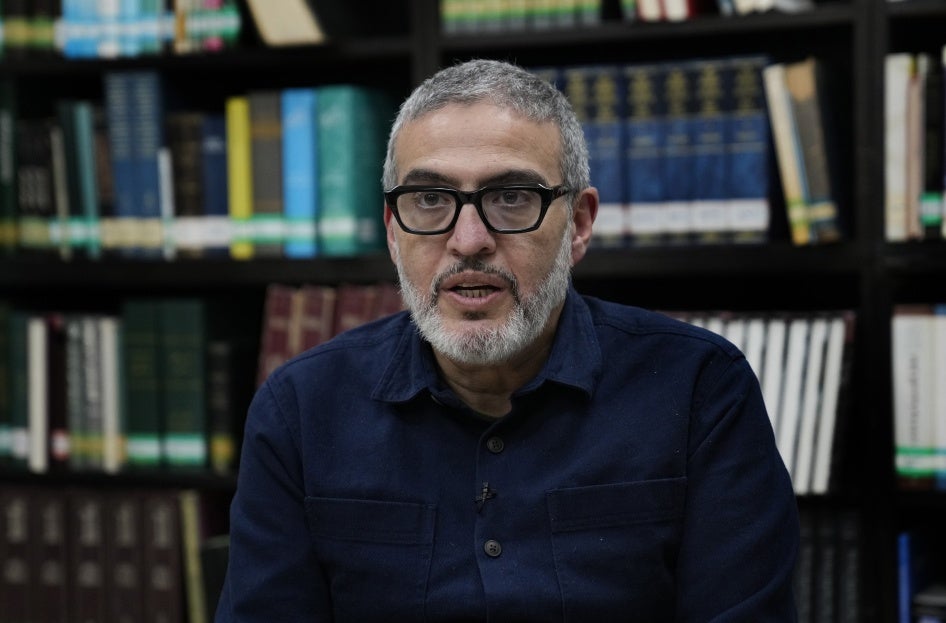 Dr. Ghassan Abu Sittah, a Palestinian-British plastic surgeon specializing in conflict medicine, speaks during an interview at the Institute for Palestine Studies in Beirut, Lebanon, December 9, 2023. © 2023 AP Photo/Hussein Malla