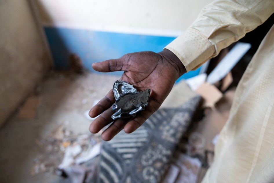 A resident of the Ridina district in N'Djamena shows the fragments of a projectile, that fell into a house on May 9, 2024, in N'Djamena following the announcement of the provisional results of the Chad presidential elections.