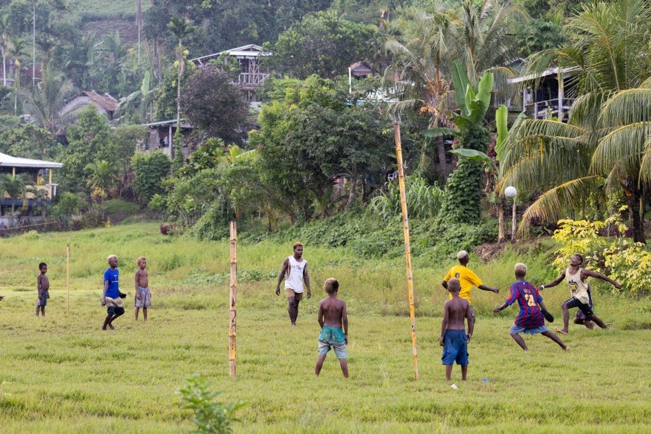 Children playing in the rain in the new site of Walande.