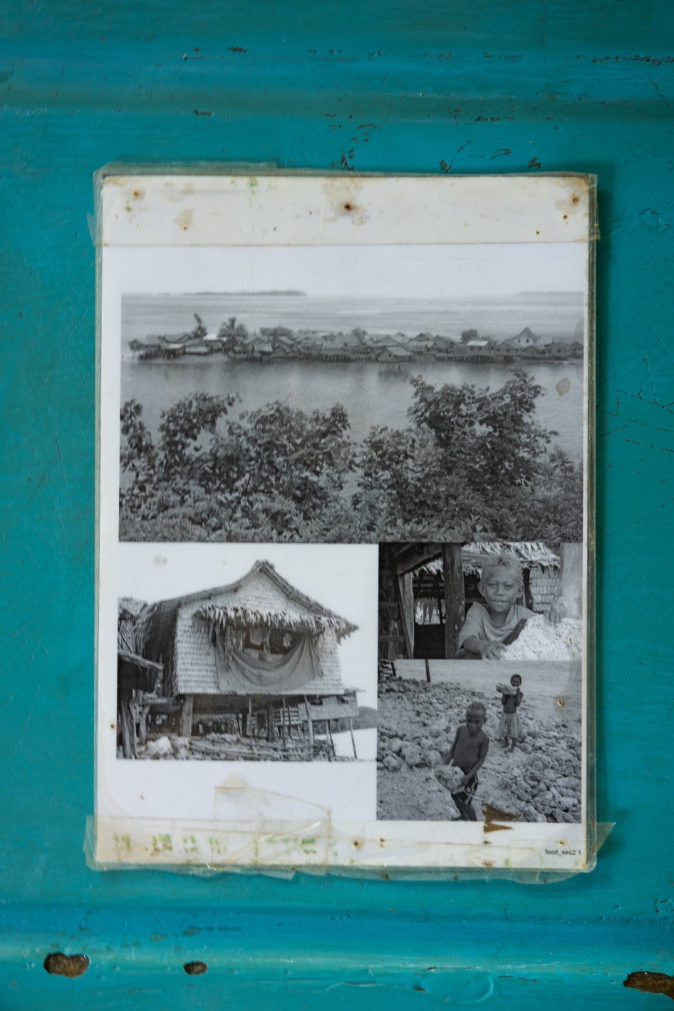 Photographs of their former island home in community archives, Walande.