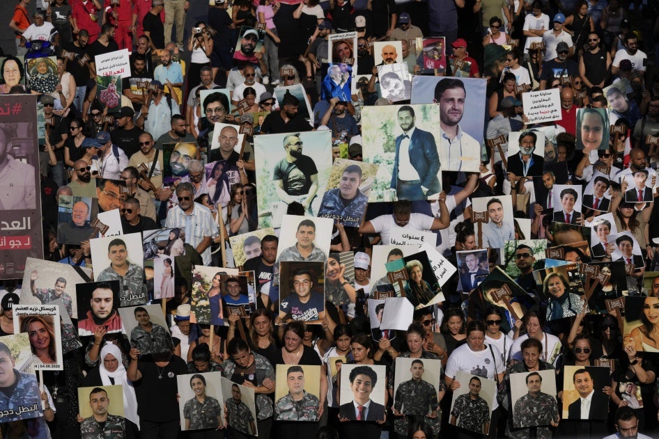 Relatives of the victims of the deadly 2020 Beirut blast hold portraits of their loved ones on the fourth anniversary of the blast, August 4, 2024.