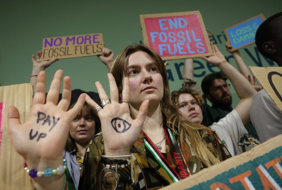 Activists with painted hands protest against fossil fuels and for climate finance at the COP29 Climate Conference in Baku, Azerbaijan, November 22, 2024.
