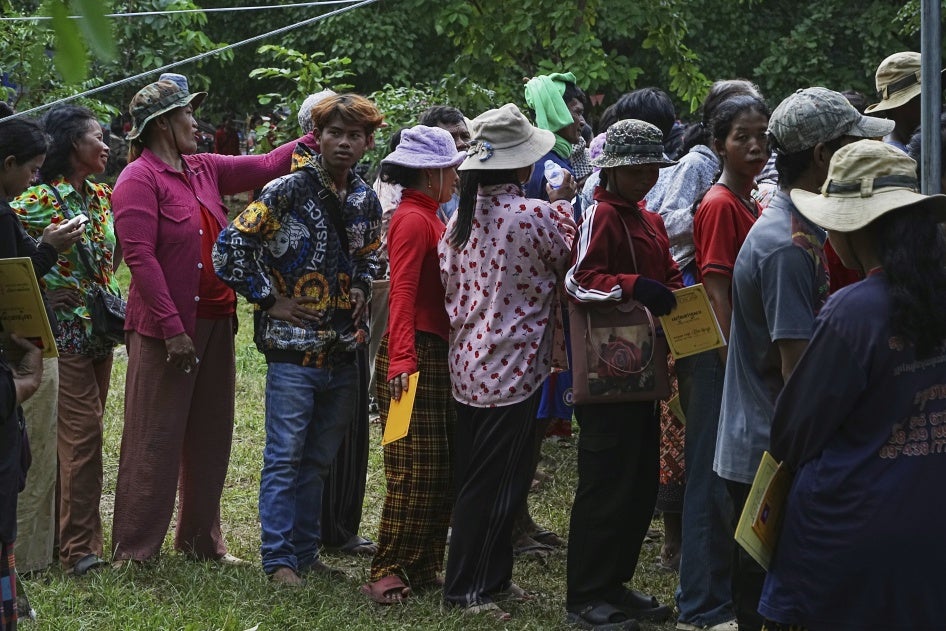 Cambodians who fled Thai-Cambodian border clashes line up to receive assistance in Oddar Meanchey province, Cambodia, July 25, 2025. 