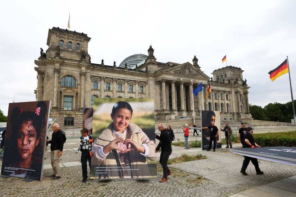 Activists set up pictures of children from Gaza in front of the Reichstag building during a protest calling for greater commitment of the German government to the children of Gaza and the defense of international law, in Berlin, Germany, July 9, 2025.