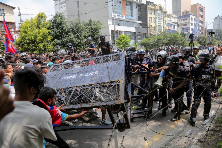 Protesters topple a police barricade blocking the route to parliament in Kathmandu, Nepal, September 8, 2025.