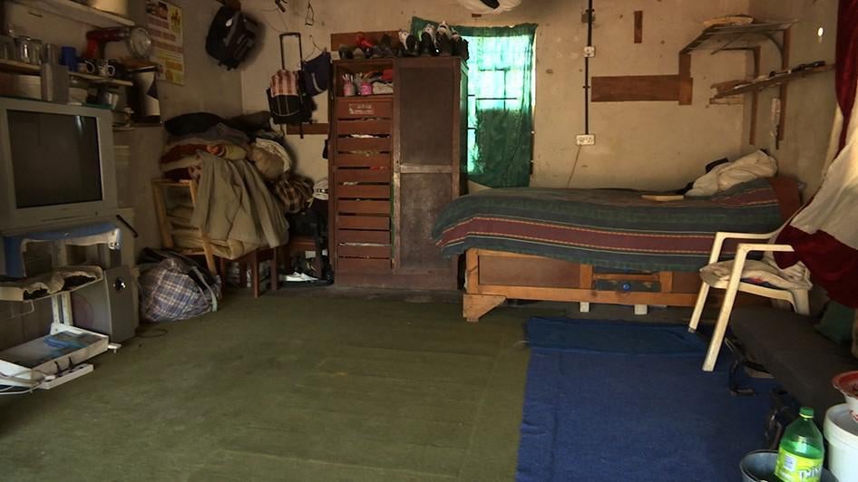 Justine’s home, a dimly lit garage. 