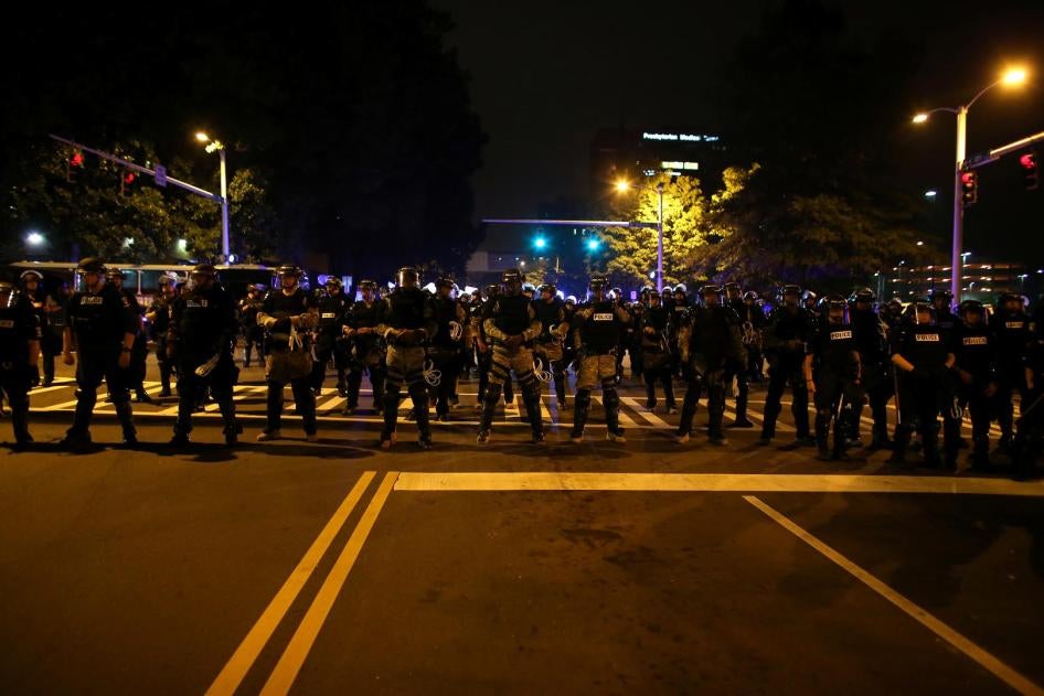 Police in riot gear block a roadway to stop demonstrators from entering a neighborhood as they protest the police shooting of Keith Scott in Charlotte, North Carolina, U.S., September 25, 2016.