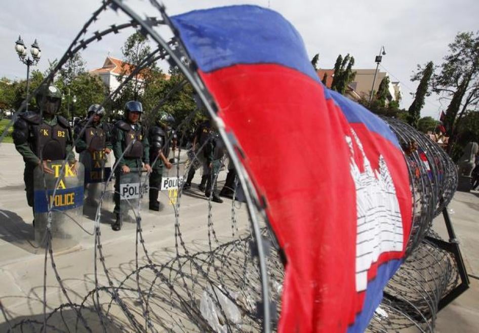Police officers stand guard at Freedom Park during the demonstration in Phnom Penh on July 15, 2014. 