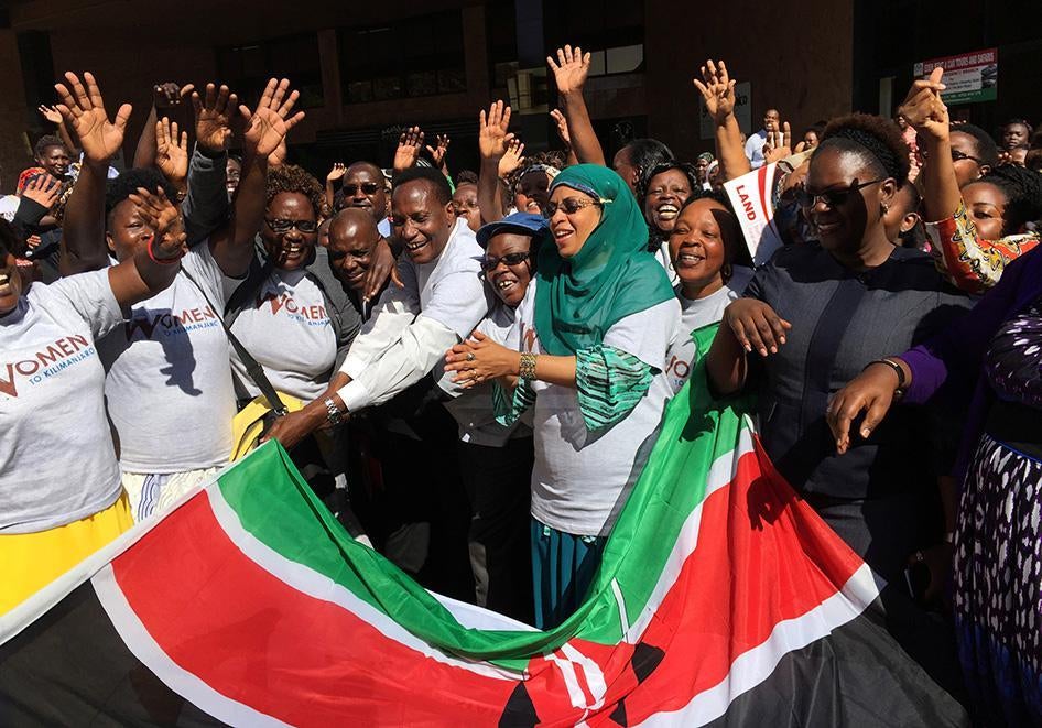 Kenya's Lands Minister and principal secretary in the Lands and Physical Planning Ministry welcome a group of women on October 13, 2016 who will climb Mount Kilimanjaro on October 14 as part of a campaign for land rights in Nairobi, Kenya.