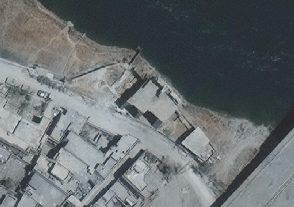 Satellite imagery from July 12 showing the building and Tigris riverbank seen in a video posted of soldiers throwing a detainee off a cliff in west Mosul as well as military vehicles in the vicinity. 