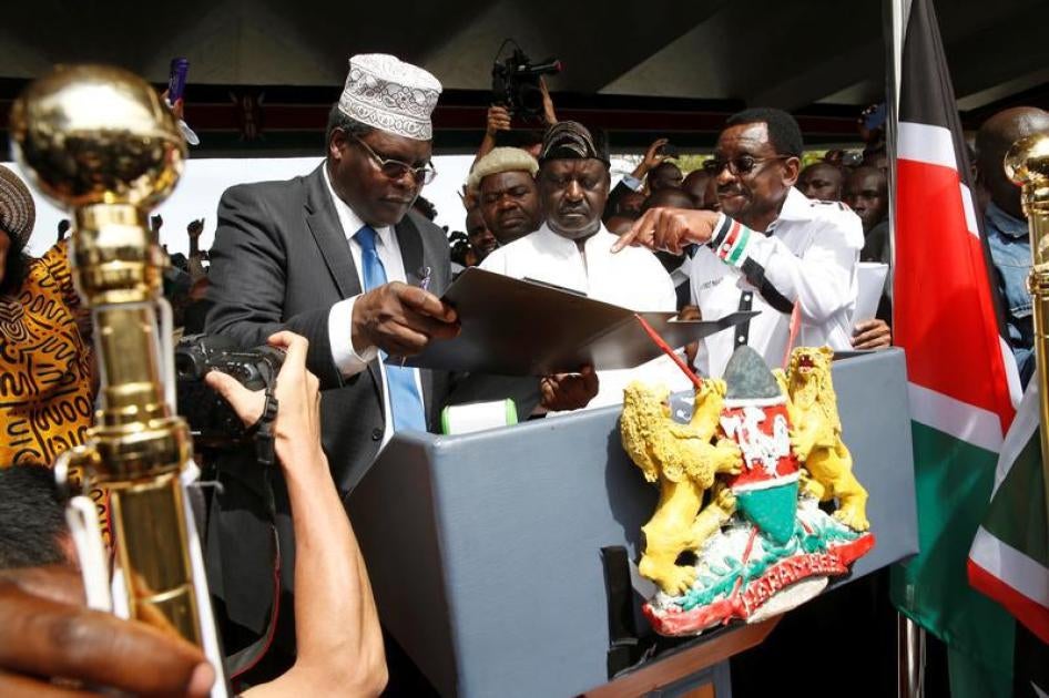 Miguna Miguna (left) partakes in Kenyan opposition leader Raila Odinga’s symbolic presidential oath of office, Nairobi, Kenya, January 30, 2018. 