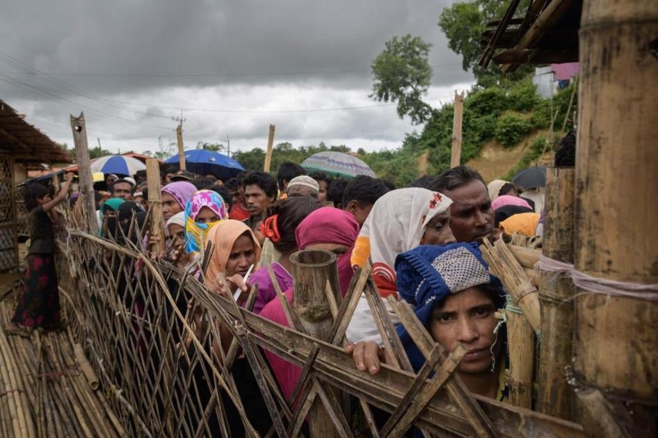 Rohingya refugees line up at an aid relief distribution center at the Balukhali refugee camp near Cox’s Bazar, Bangladesh, August 12, 2018.
