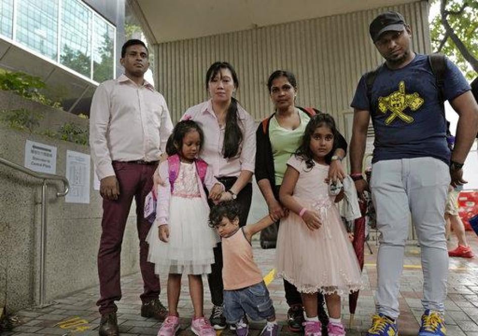 Asylum seekers, from left: Ajith Pushpa Kumara, Vanessa Mae Rodel and her daughter Keana, Nadeeka Dilrukshi Nonis and her son Dinath and daughter Sethmundi Kellapatha, and Supun Thilina Kellapatha, pose outside the building of Hong Kong's immigration depa