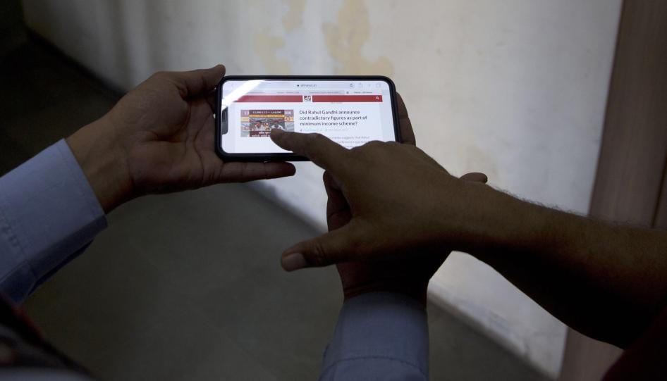 Indians look at a fact-checking website for election related fake news and videos, New Delhi, India, April 3, 2019.