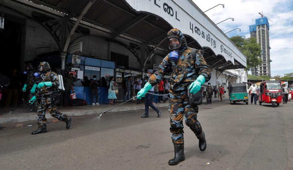 Sri Lankan government soldiers in protective clothes spray disinfectants at a railway station in Colombo, Sri Lanka, Wednesday, March 18, 2020.