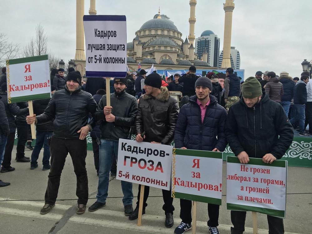 Men standing with signs “I’m for Kadyrov” and “Kadyrov is the Scourge of the Fifth Column” at a mass pro-Kadyrov rally organized by Chechen authorities in Grozny in January 2016.
