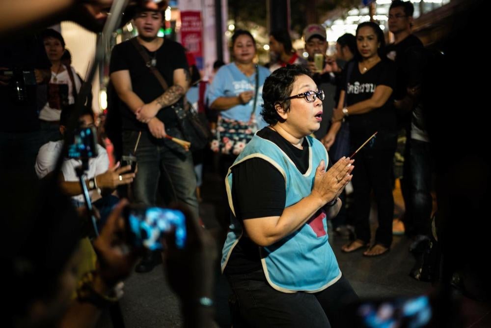 On August 30, 2017, Phayao Akhard wears the bloody nurses gown worn by her daughter, nurse Kamolkate “Kate” Akhard, when she was killed by Thai Special Forces soldiers while tending wounded persons at the front of Wat Pathum temple on May 19, 2010, to pro