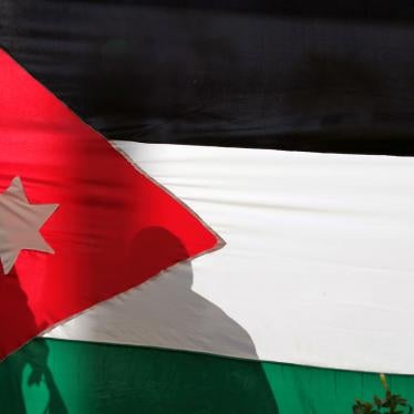 Silhouettes are cast on a Jordanian national flag in Amman, Jordan, November 30, 2016. 