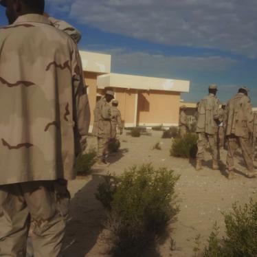 A group of uniformed men standing around a compound