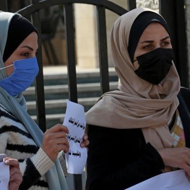 Women hold signs during a protest against the decision by Gaza's Supreme Judicial Council banning women from movement in and out of the Gaza Strip without the permission of her "guardian," in Gaza City, February 16, 2021. 