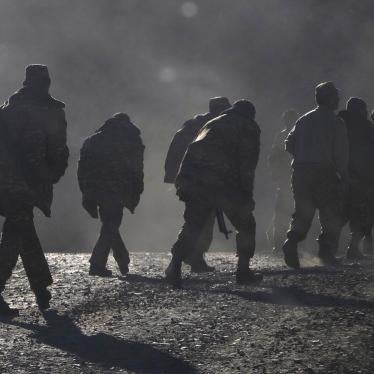 Ethnic Armenian soldiers walk along the road near the border between Nagorno-Karabakh and Armenia, Sunday, Nov. 8, 2020.