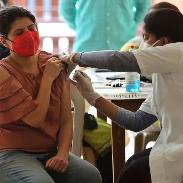 A woman receives the AstraZeneca vaccine for Covid-19 at an apartment building in Bengaluru, India, April 24, 2021.