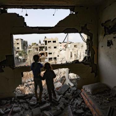 Palestinian children observe the damage from homes Gaza City