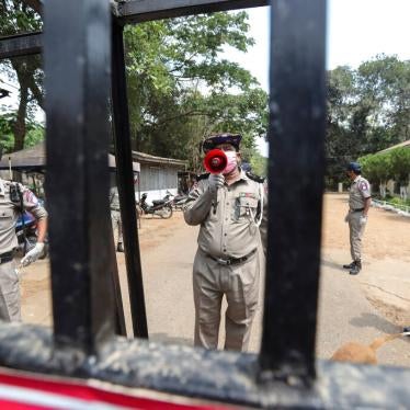 An official with a megaphone during the release of prisoners from Insein prison after a presidential pardon in Yangon