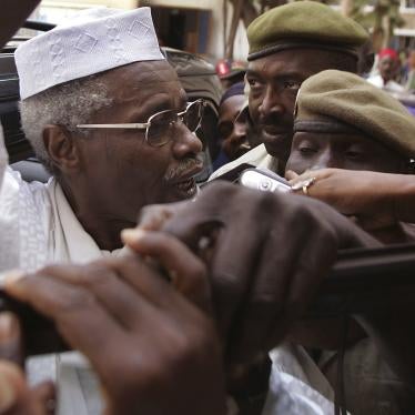 A man in a white hat surrounded by soldiers