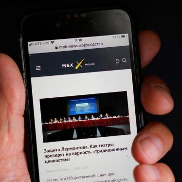 A smart phone user reads MBKh Media news site, one of three news outlets whose websites were blocked on August 4, 2021.