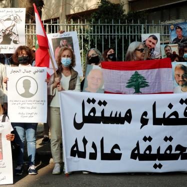 Families of Port Blast's victims show portraits of their beloved ones near the Palace of Justice in Beirut, November 25, 2021. Relatives of victims call for an independent judiciary to achieve justice.