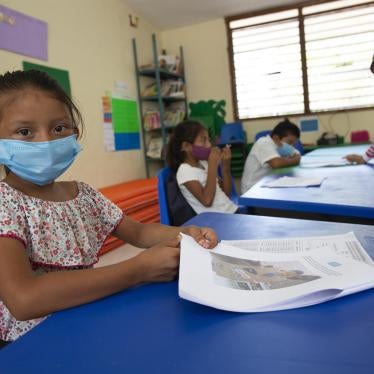 A child wears a face mask in a classroom