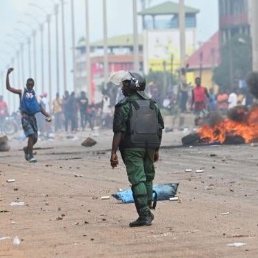 A police officer looks on as supporters of the opposition coalition, National Front for the Defence of the Constitution (FNDC), block roads after authorities banned them from protesting in Conakry, Guinea, July 28, 2022. 