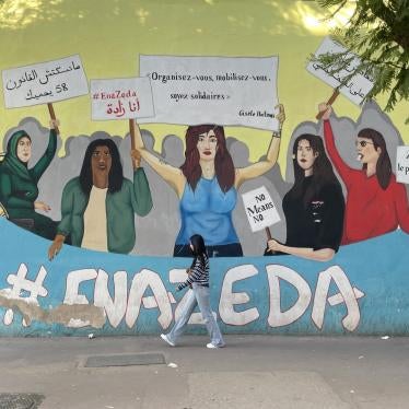 A woman walks by a street mural 