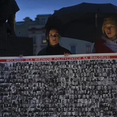 Members of the Belarusian diaspora outside the Adam Mickiewicz monument in Krakow, Poland.