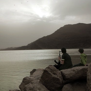 A boy, believed to be recruited by the Houthis, holds an AK-47 while overlooking the high dam in Marib, Yemen, July 30, 2018.