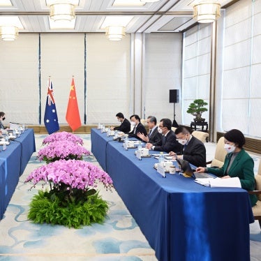 People seated around two tables opposite of each other