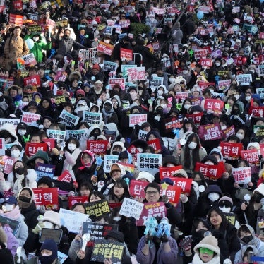 Protesters gather holding banners demanding the impeachment of South Korea's president