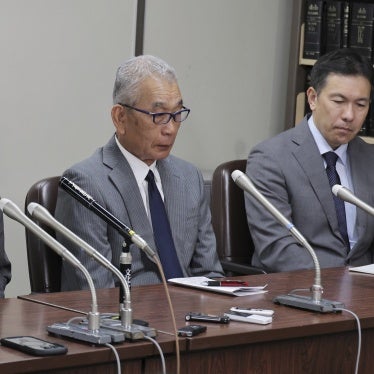 Three men attend a press conference
