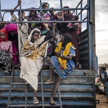 refugees get off a truck loaded with families