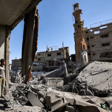 A boy stands amid the ruins of a collapsed building following Israeli bombardment in the Bureij camp for Palestinian refugees in the central Gaza Strip, May 23, 2025.