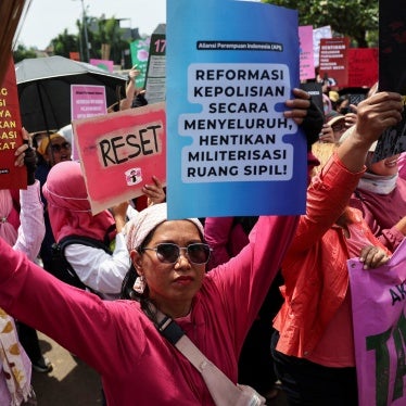 Protesters brandish brooms as a symbol of their calls for reform, and ending police brutality and lawmakers’ perks, outside the Indonesian parliament building in Jakarta, September 3, 2025. (