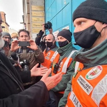 Pastor Gábor Iványi of the Hungarian Evangelical Fellowship speaks with National Tax and Customs officials during an armed raid on his church’s center in Budapest, Hungary on February 21, 2022. 
