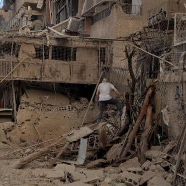 A man walks on debris in the Palestinian Yarmouk refugee camp, on the southern outskirts of Damascus, June 3, 2015. 