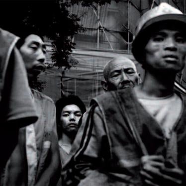 Migrant workers wait for buses to transport them to construction sites in Beijing.