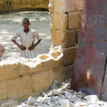 Children look through a destroyed classroom window at Yerwa Primary School, Maiduguri, Borno state, damaged by Boko Haram during attacks in 2010 and 2013. The school, established in 1915, was the first primary school in northeast Nigeria. © 2015 Bede Shep