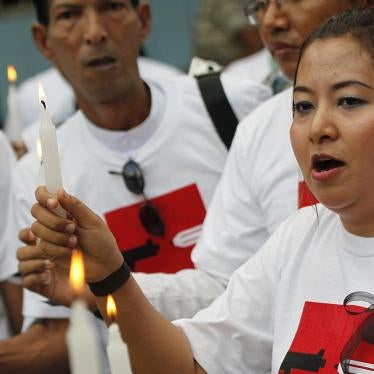 Shwe Hmone and other Burmese journalists pray at Sule Pagoda in Rangoon for colleagues killed or imprisoned for their work\.