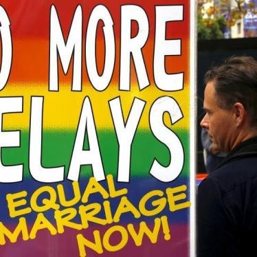 Activists stand next to a banner as they listen to speeches during a rally supporting same-sex marriage in Sydney, Australia May 31, 2015. 